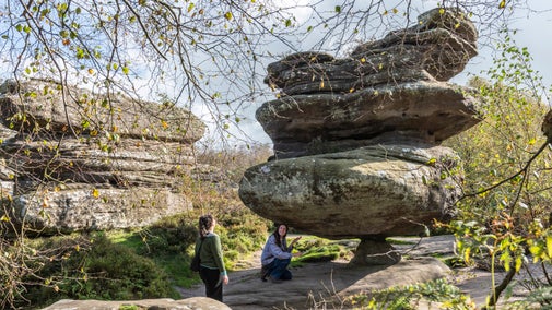 Visitors exploring Idol Rock at Brimham Rocks